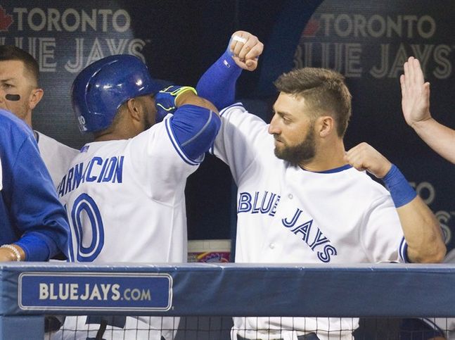 Toronto Blue Jays Kevin Pillar greets teammate Edwin Encarnacion after Encarnacion hit a three run home run against the Minnesota Twins during fourth inning AL baseball action in Toronto