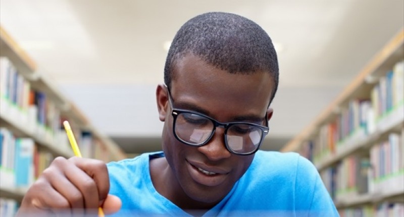 039 African American Male College Student Sitting At Desk&#039