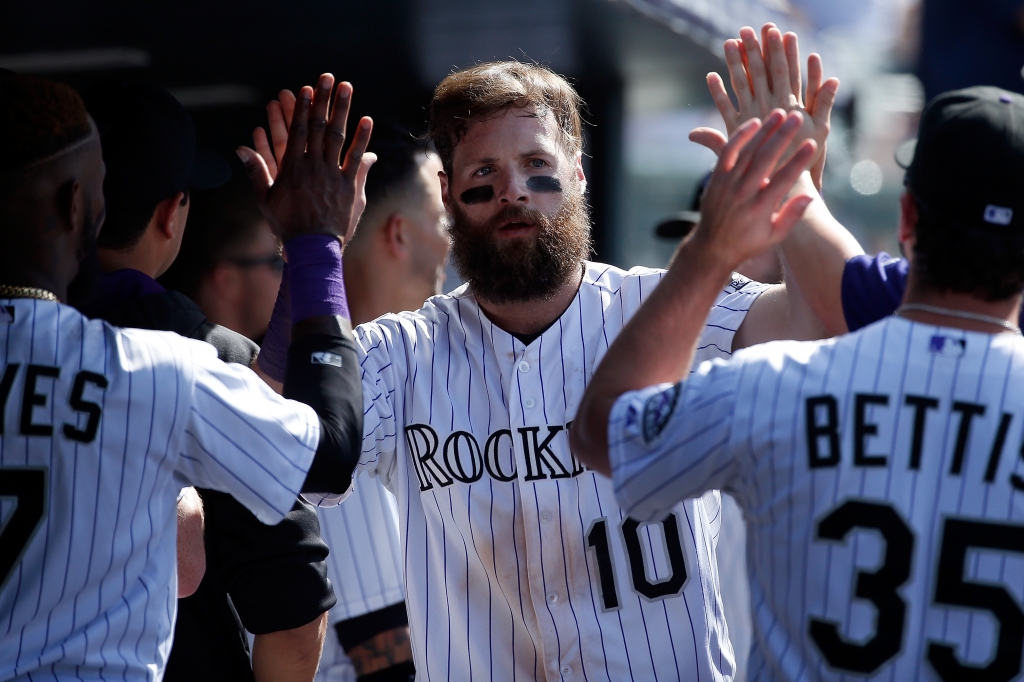 DENVER CO- AUGUST 05 Ben Paulsen #10 of the Colorado Rockies celebrates after scoring on a single by Kyle Parker #16 of the Colorado Rockies to tie the score 5-5 in the ninth inning during interleague play at Coors Field