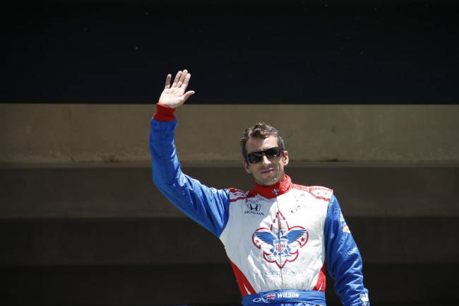 Justin Wilson of England waves before competing in the Pocono Indy Car 500 auto race Sunday