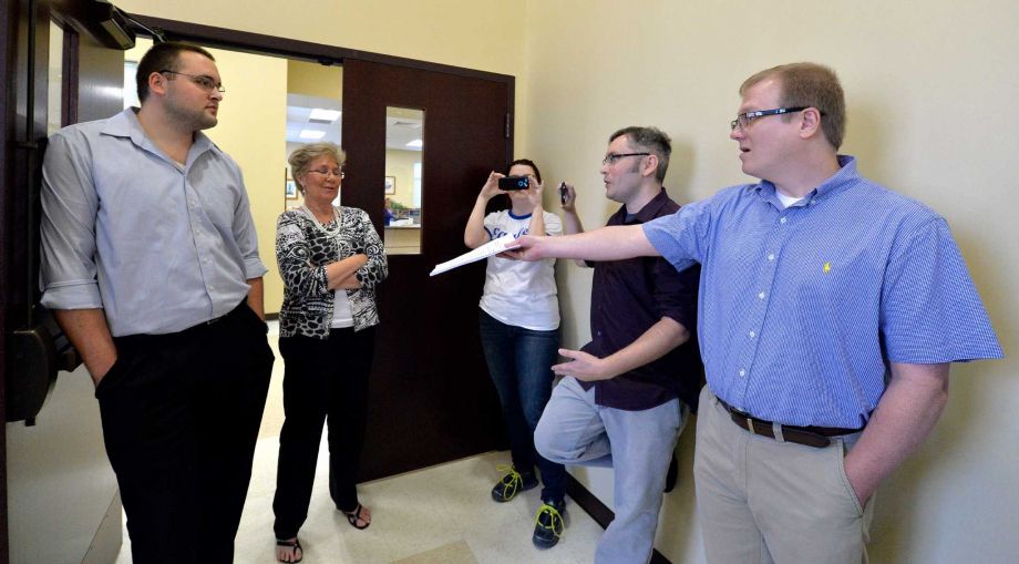 David Ermold right who wants to marry his partner of 17 years attempts to hand Rowan County Ky. clerks Nathan Davis left and Roberta Earley a copy of the ruling from a federal judge instructing the county to start issuing marriage licenses. Rowan