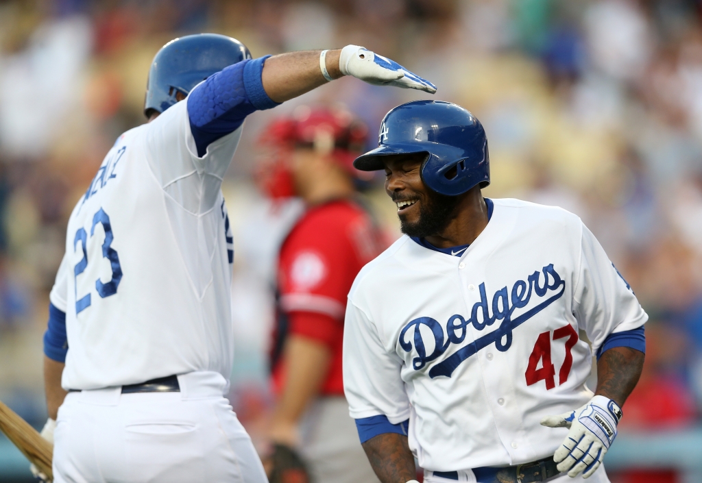 LOS ANGELES CA- JULY 31 Howie Kendrick #47 of the Los Angeles Dodgers is greeted by on deck batter Adrian Gonzalez #23 as he returns to the dugout after hitting a solo home run in the first inning against the Los Angeles Angels of Anaheim at Dodger St