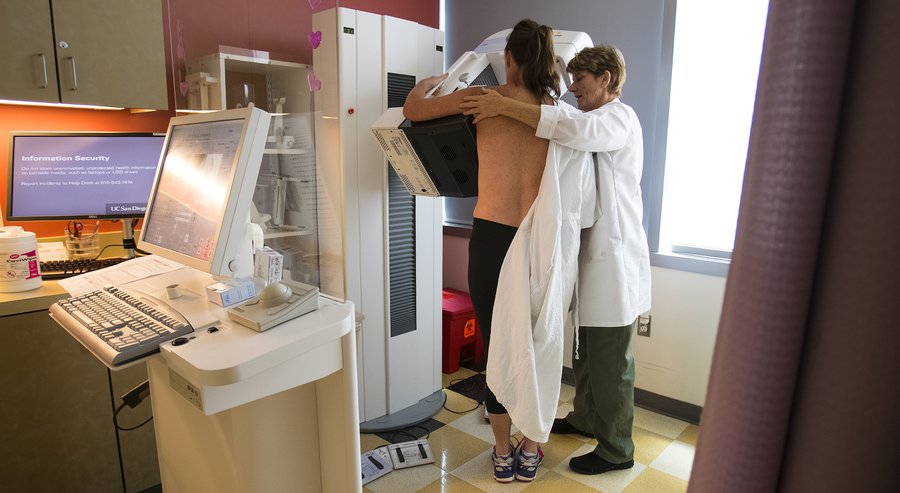 Kimberly Kirkpatrick undergoes a mammogram procedure at UCSD Moores Cancer Center with the help of Barbara Thayer RT RM