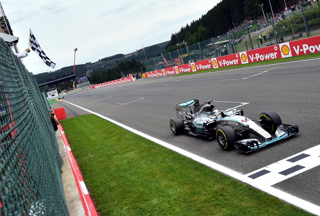 Lewis Hamilton crosses the line to win the Belgian grand prix and extend his lead over Mercedes team-mate Nico Rosberg