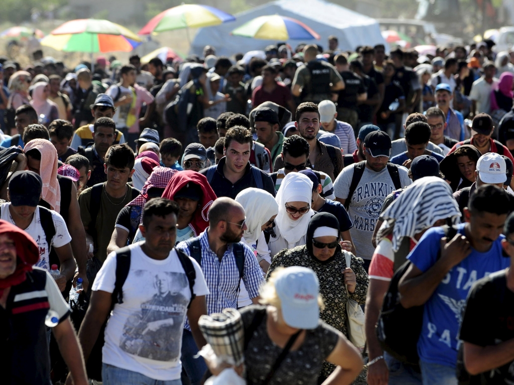 Migrants queue to continue their journey north at a newly built registration and transit center near Gevgelija Macedonia on More