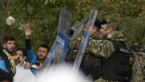 Macedonian police clash with migrants