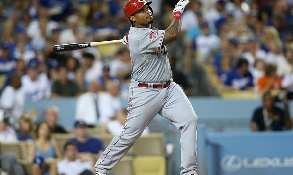 LOS ANGELES CA- AUGUST 13 Marlon Byrd #9 of the Cincinnati Reds hits a acrifice fly to bring in Todd Frazier #21 in the fourth inning against the Los Angeles Dodgers at Dodger Stadium