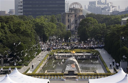 Doves fly over the cenotaph dedicated to the victims of the atomic bombing at the Hiroshima Peace Memorial Park during the ceremony to mark the 70th anniversary of the bombing in Hiroshima western Japan Thursday Aug. 6 2015. AP