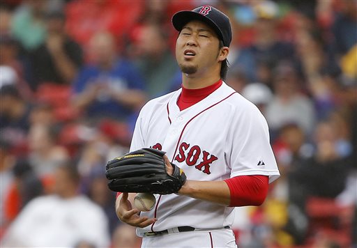 Boston Red Sox relief pitcher Junichi Tazawa drops the ball into his hand during the ninth inning of their 8-6 loss to the Kansas City Royals in a baseball game at Fenway Park in Boston Sunday Aug. 23 2015