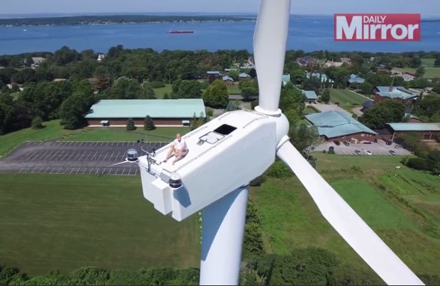 Drone captures man sunbathing on top of a 200 feet tall windmill! 