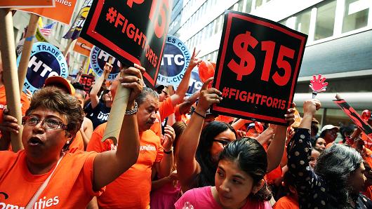 Labor leaders workers and activists attend a rally for a $15 minimum hourly wage