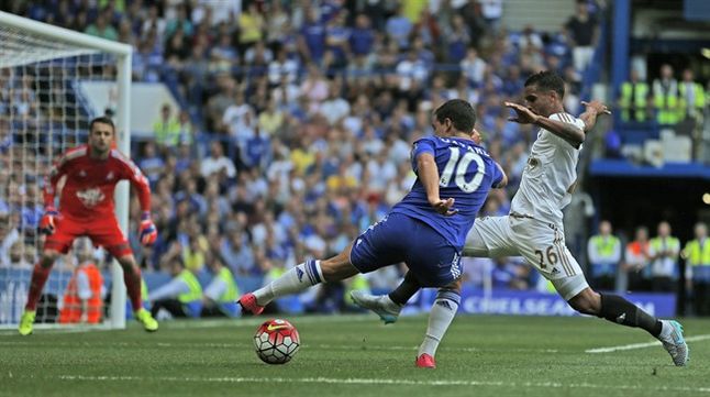 Chelsea's Eden Hazard center and Swansea's Kyle Naughton challenge for the ball during the English Premier League soccer match between Chelsea and Swansea City at Stamford Bridge stadium in London Saturday Aug. 8 2015