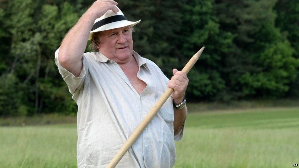 Gerard Depardieu rests during hand-scything