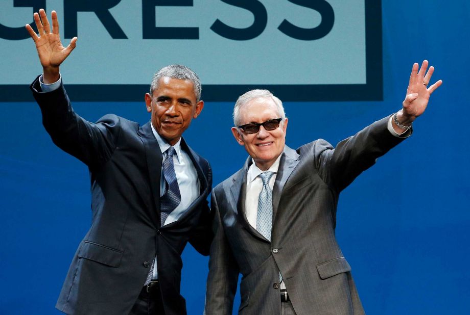 President Barack Obama left and Senate Minority Leader Sen. Harry Reid wave onstage at the National Clean Energy Summit Monday Aug. 24 2015 in Las Vegas. The president used the speech to announce a set of executive actions and other efforts aimed