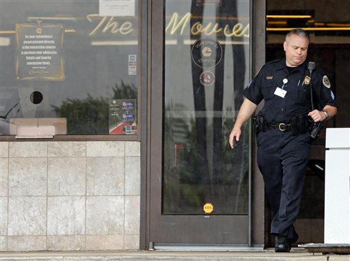 A police officer leaves the lobby of a movie theater complex Thursday Aug. 6 2015 in Antioch Tenn. where an investigation continues after police respond to an attacker Wednesday. What initially appeared to be another mass shooting at a movie theater