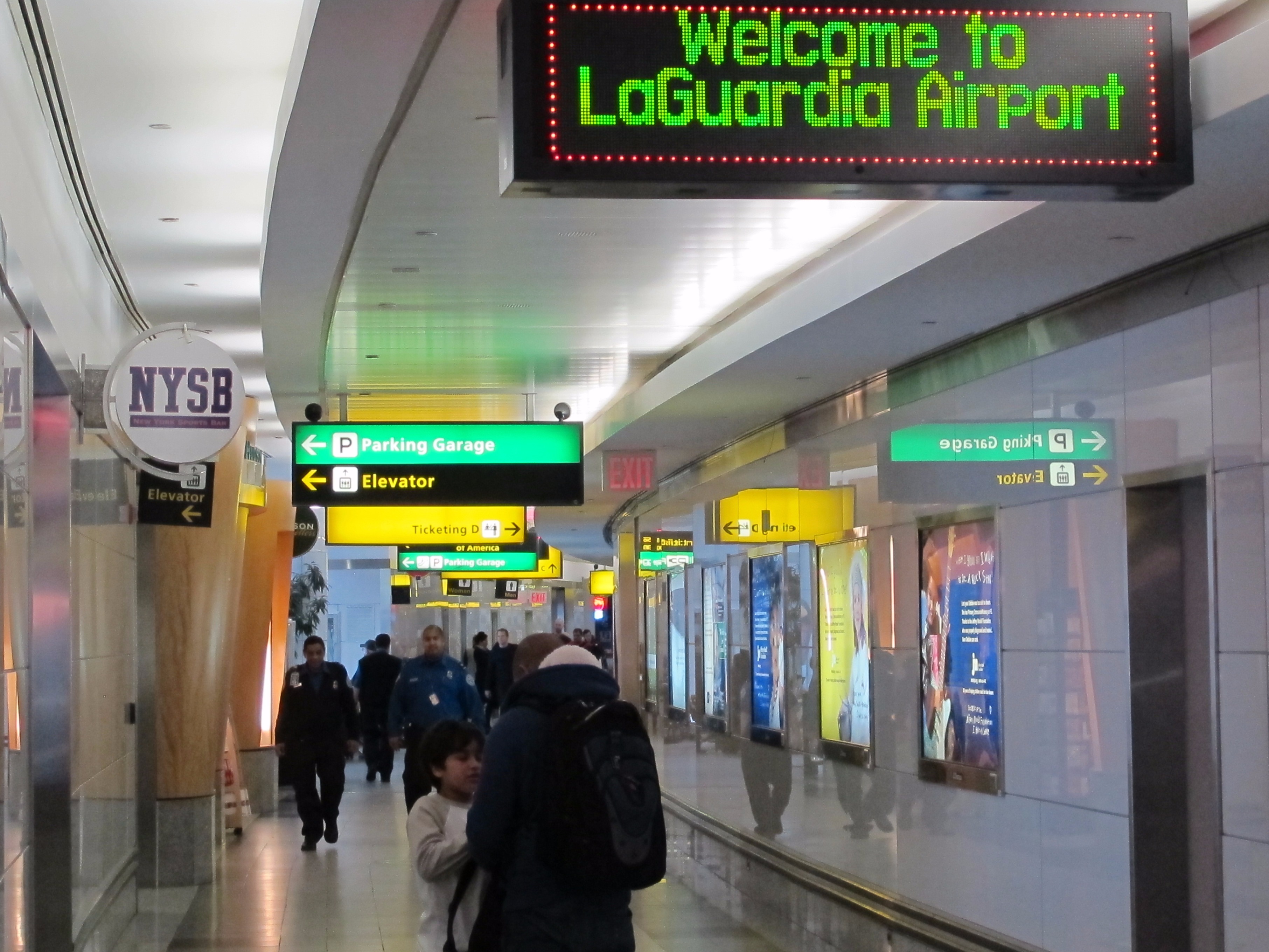 Passengers manoeuvre through cramped hallways at New York’s La Guardia Airport