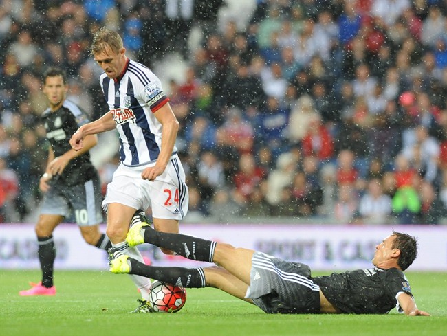 West Brom’s Darren Fletcher left is tackled by Chelsea’s Branislav Ivanovic during the English Premier League soccer match between West Bromwich Albion and Chelsea at the Hawthorns West Bromwich England Sunday Aug. 23 2015. (AP