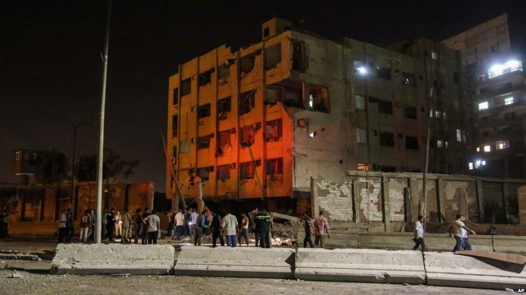 People gather outside an Egyptian national security building after a bomb exploded early Thursday Aug. 20 2015