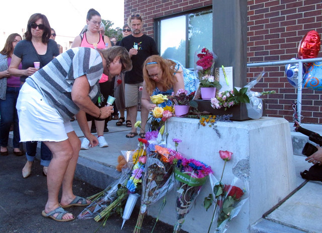 People placed flowers Sunday at the site where Lara Sobel was killed in Barre Vt. Click