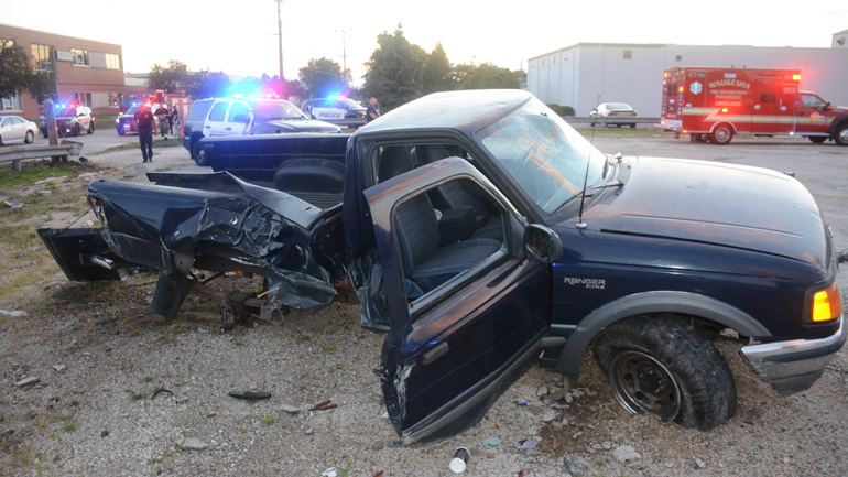 Pickup truck rolls over after ramming squad cars