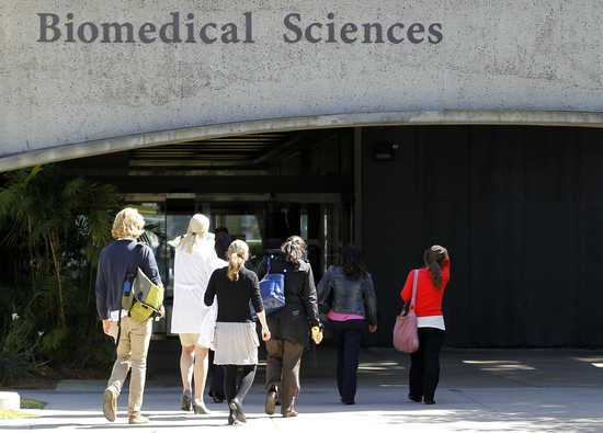 Students and facility staff enter the biomedical building at the University of California San Diego in San Diego California