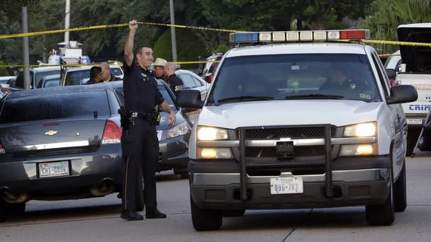 Police at the scene of a shooting at a home in Houston which left eight people dead