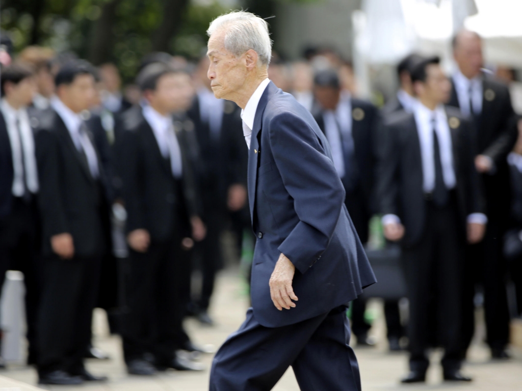 Sumiteru Taniguchi 86 a survivor of the 1945 atomic bombing of Nagasaki walks up to deliver his speech at the 70th anniversary of the atomic bombing in Nagasaki southern Japan on Sunday