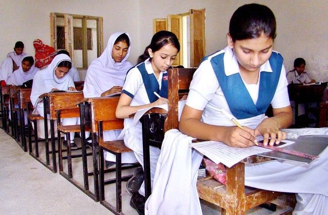 APP41-20 HYDERABAD March 20  Students busy in solving the question paper during Annual Examination of SSC Part I at Himayat-ul Islam Girls High School. APP