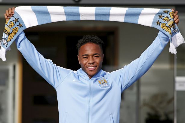 New Manchester City signing Raheem Sterling poses with a club scarf