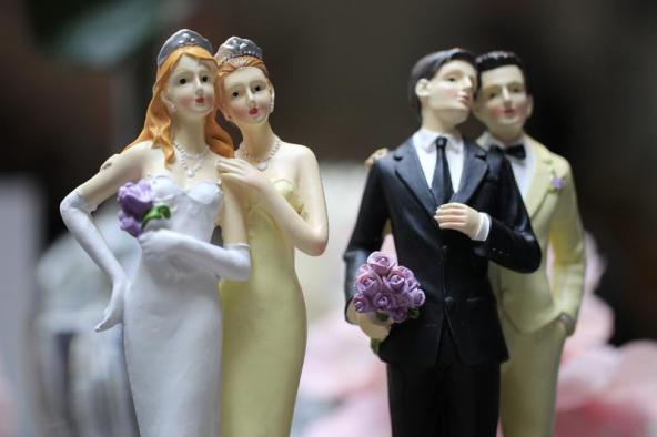 REUTERS  Gonzalo Fuentes Same-sex couple plastic figurines are displayed during a gay wedding fair in Paris