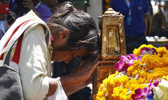 A woman prays at the shrine