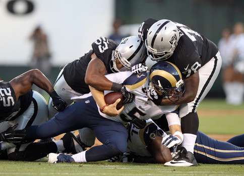 Justin Ellis #78 Malcolm Smith #53 and Khalil Mack #52 of the Oakland Raiders sack Nick Foles #5 of the St. Louis Rams