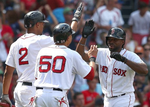 Jackie Bradley Jr. #25 of the Boston Red Sox celebrates with Mookie Betts #50 and Xander Bogaerts #2 after scoring against the Seattle Mariners leaves the game in the third inning against the Boston Red Sox at Fenway Park. (Mandatory Credit ESPN  Getty Im