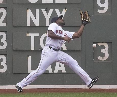 Boston MA 8/23/15 Boston Red Sox Jackie Bradley Jr has trouble fielding Kansas City Royals Omar Infante's triple but recovered to throw him out at home plate during ninth inning action at Fenway Park on Sunday