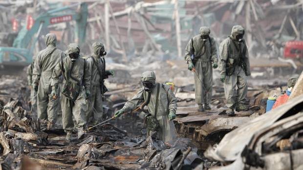 Rescue workers spray hydrogen peroxide over the debris at the blast site at Tianjin warehouse