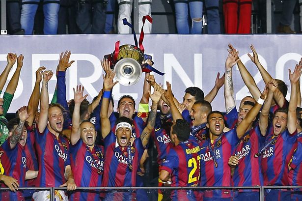 Barcelona's Xavi celebrates with the trophy and team mates after winning the UEFA Champions League