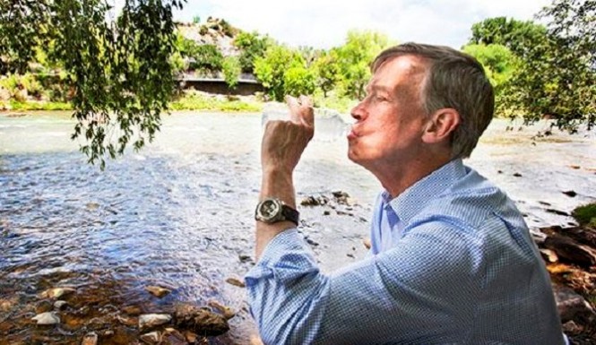 Gov. John Hickenlooper drinks from Animas River