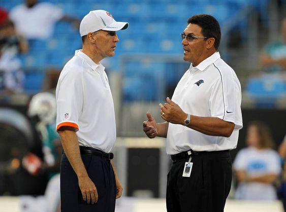 Carolina Panthers head coach Ron Rivera right talks with Miami Dolphins head coach Joe Philbin left before a preseason NFL football game in Charlotte N.C. Panthers coach Ron Rivera says he and Dolphins