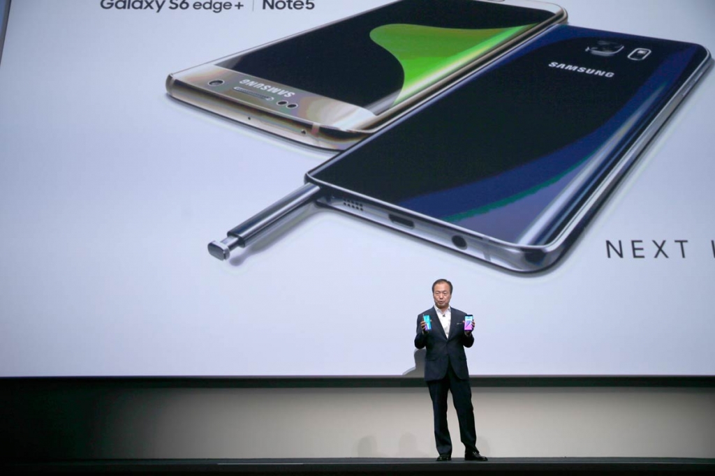 JK Shin president and CEO of Samsung Electronics holds the Samsung Galaxy S6 Edge Plus left and the Samsung Galaxy Note 5 during a presentation Thursday Aug. 13 2015 at Lincoln Center in New York