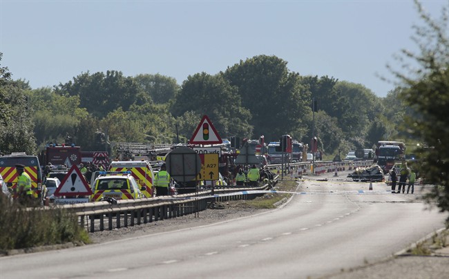 Emergency services attend the scene on the A27 road after a plane crashed into cars during an aerial display at the Shoreham Airshow in West Sussex England Saturday Aug. 22 2015