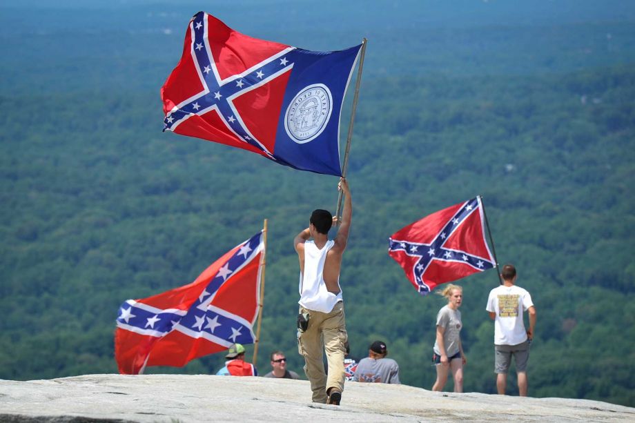 Confederate flag supporters demonstrate atop Stone Mountain as they protest what they believe is an attack on their Southern heritage during a rally at Stone Mountain Park in Stone Mountain Ga. on Saturday Aug. 1 2015. (John Amis  Atlanta Journal-Const