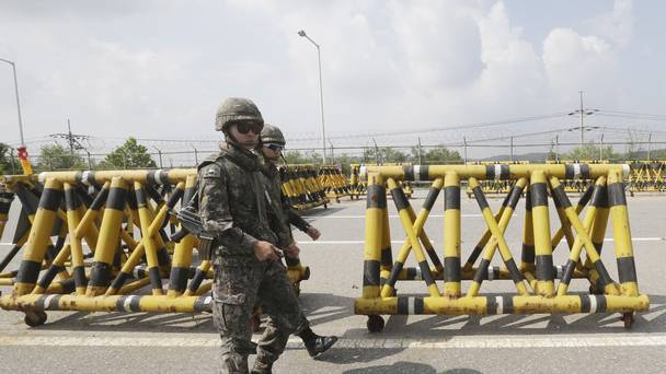 South Korean army soldiers adjust barricades set up on Unification Bridge which leads to the demilitarised zone in Paju