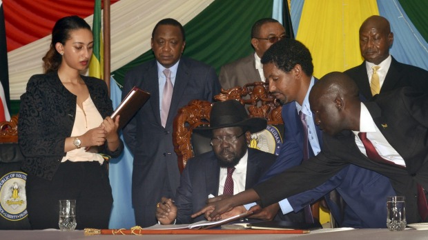 South Sudan President Salva Kiir seated signs a peace deal on Wednesday watched by Kenya's President Uhuru Kenyatta centre-left Ethiopia's Prime Minister Hailemariam Desalegn centre-right and Uganda's President Yoweri Museveni right