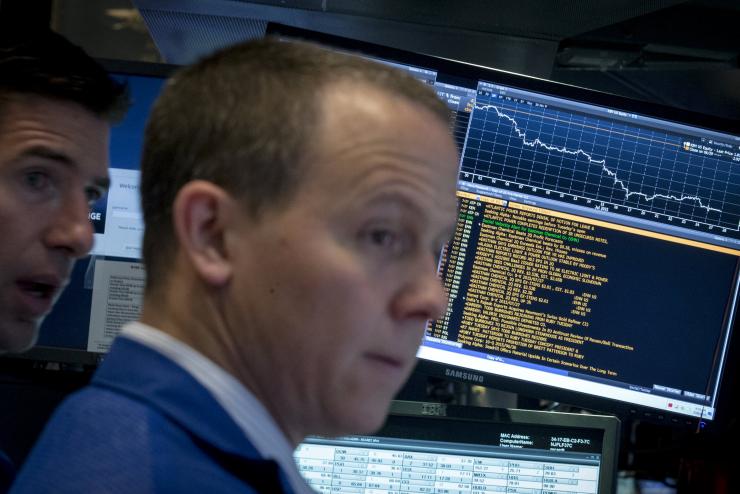 Specialist traders work at their post on the floor of the New York Stock Exchange