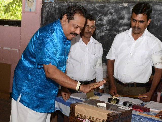 Former Sri Lankan president and parliamentary candidate Mahinda Rajapakse casts his ballot at a polling station in his native town of Tangalla about 195 kms from the capital Colombo