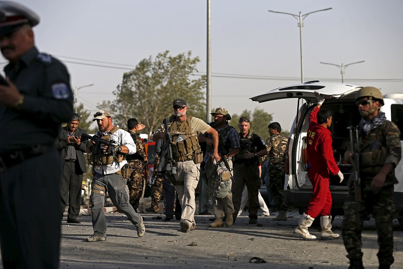 Foreign security contractors arrive at the site of a bomb blast in Kabul Afghanistan today A car bomb exploded outside a private hospital in Kabul o killing one person and injuring 18 more a senior health official said pic