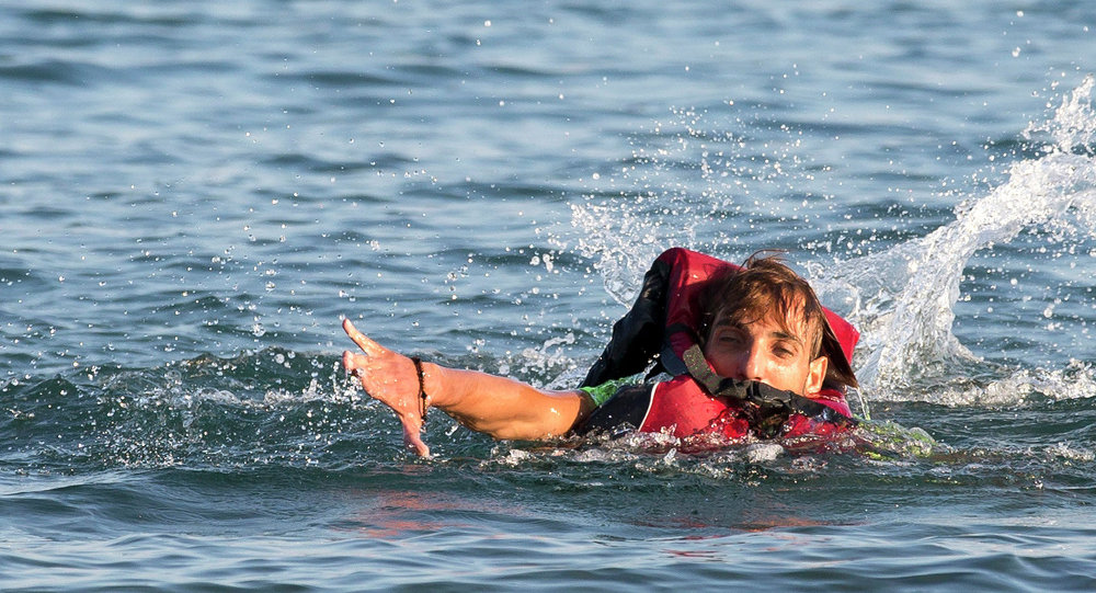 Migrants and refugees one of them swims arrive after crossing from Turkey at the southeastern island of Kos Greece Monday Aug. 17 2015