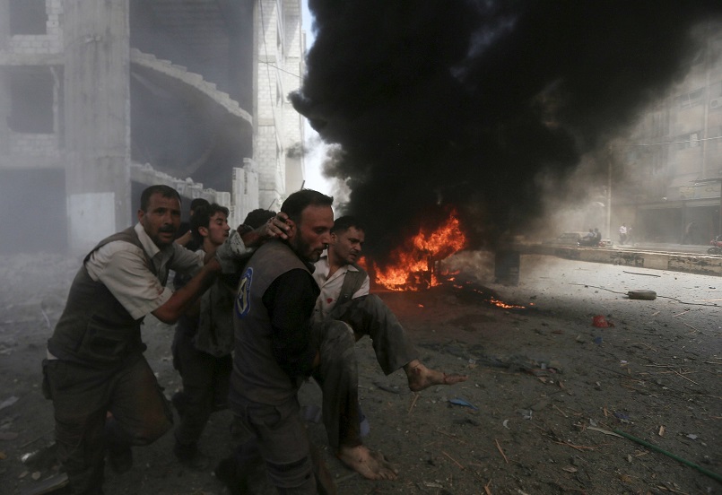 Men transport a casualty after air strikes by forces loyal to Syria's President Bashar al Assad on a market place in the Douma neighborhood of Damascus