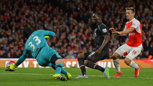 Liverpool's Christian Benteke centre is denied by Arsenal goalkeeper Petr Cech at the Emirates Stadium