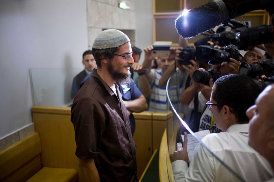 Head of a Jewish extremist group Meir Ettinger appears in court in Nazareth Illit, Israel Tuesday Aug. 4 2015. Israel said Tuesday it was interrogating the suspected head of a Jewish extremist group in the first arrest of an Israeli suspect following